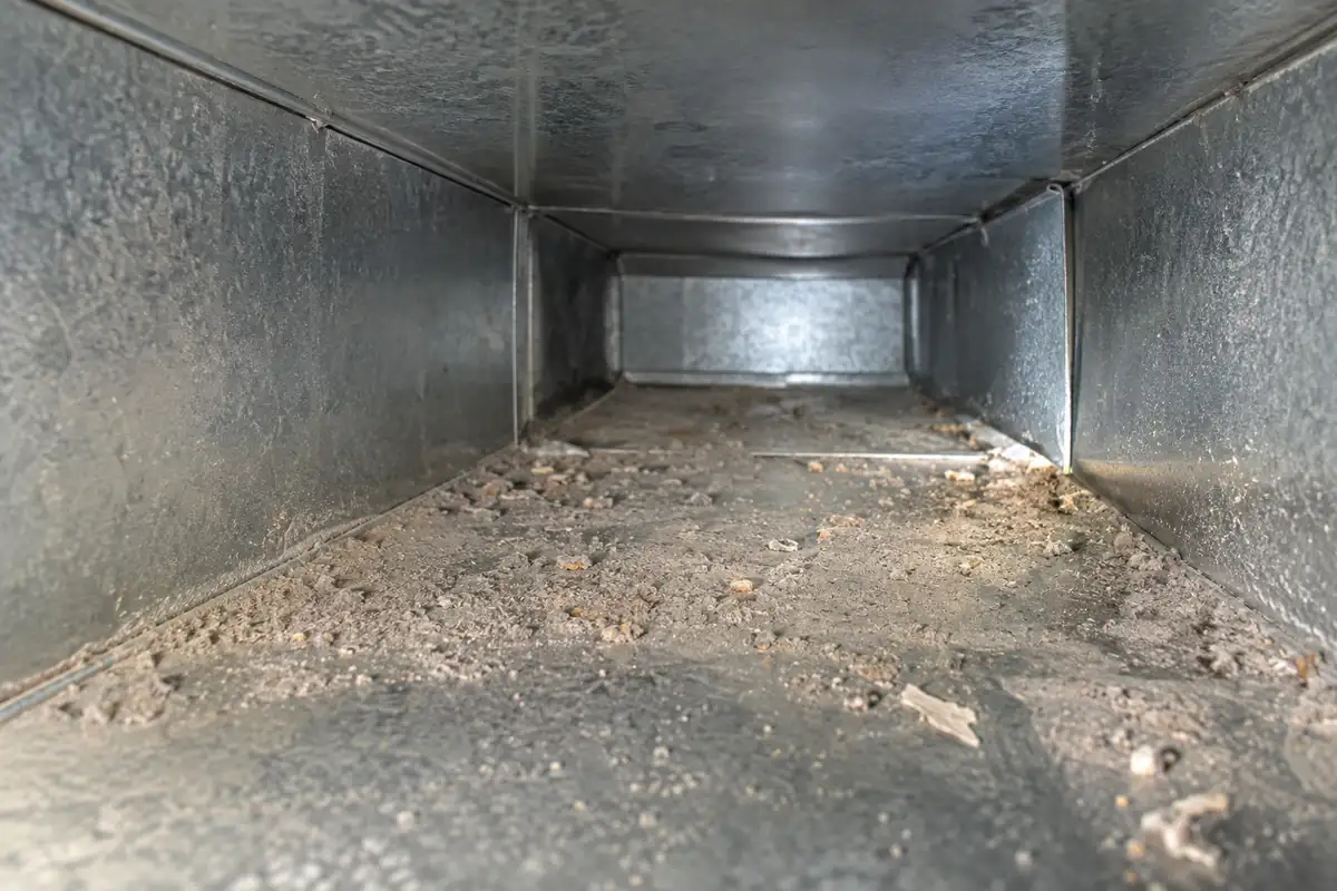 Localized dust and construction debris inside a galvanized residential AC duct