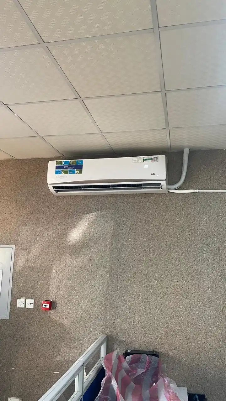 Technician installing a wall-mounted split AC unit in Dubai — supporting project view 2
