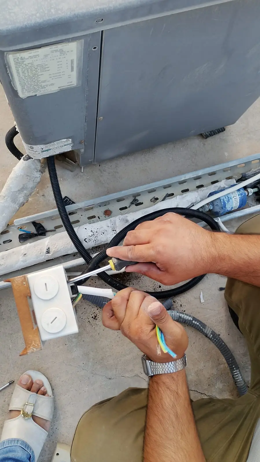 Technician installing a wall-mounted split AC unit in Dubai — supporting project view 3