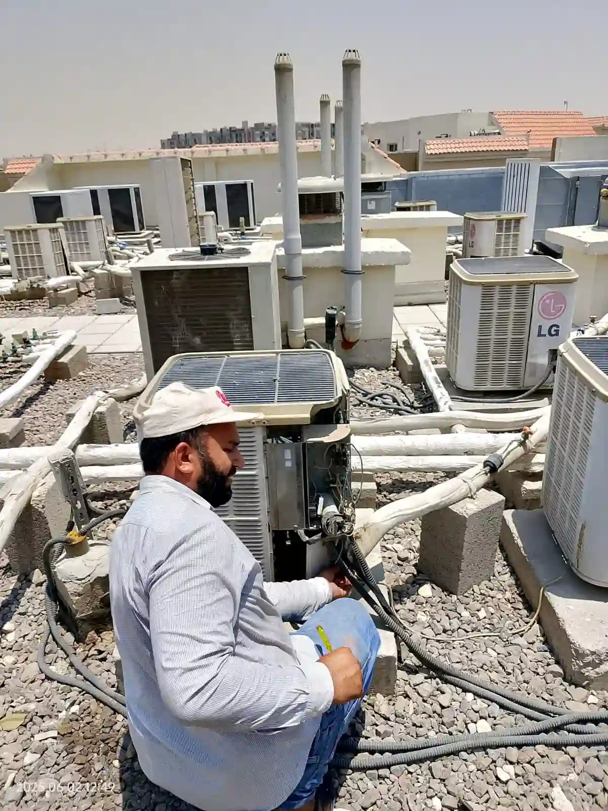 Technician checking an AC filter during maintenance in Dubai — supporting project view 1
