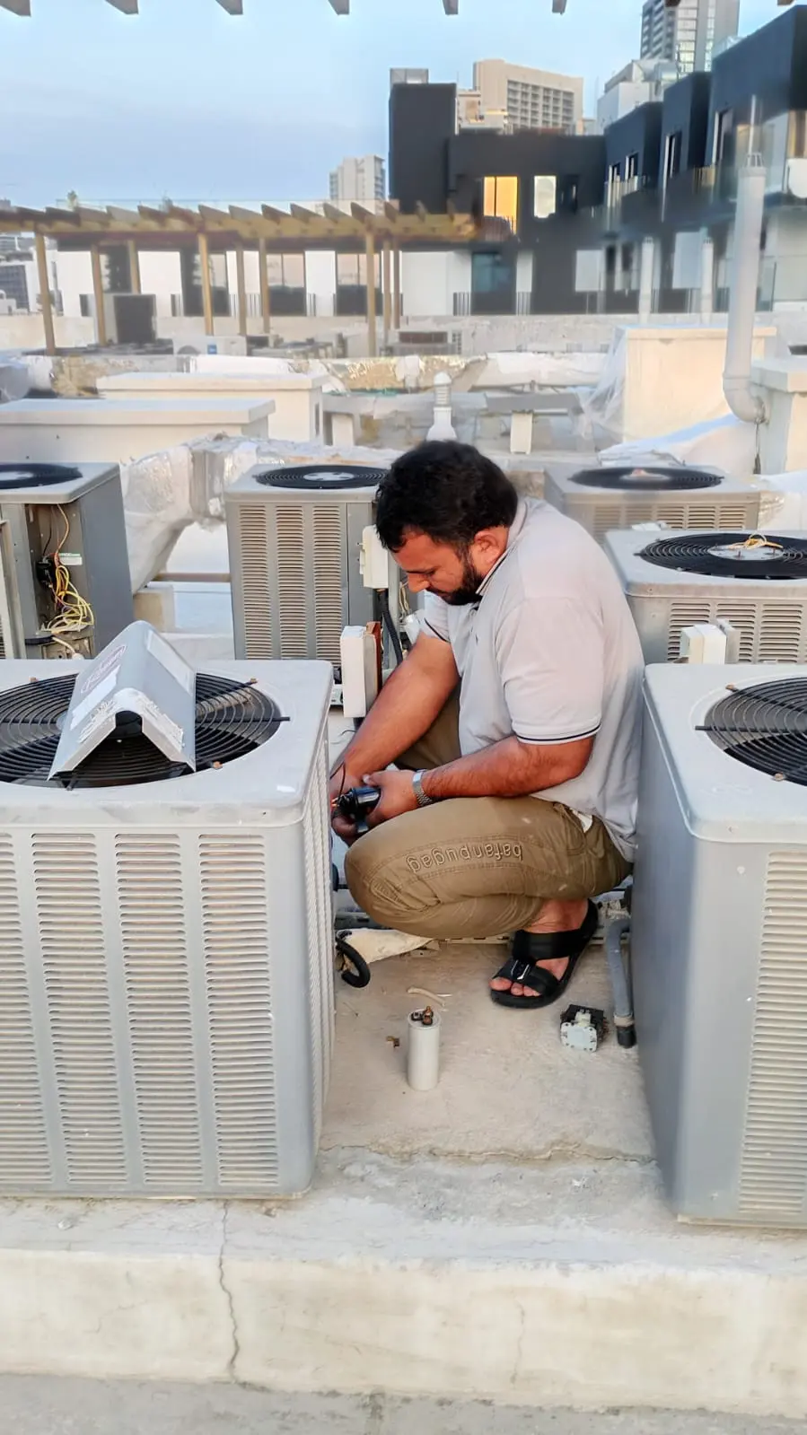 Technician servicing a wall-mounted split AC inside a Dubai home — supporting project view 1