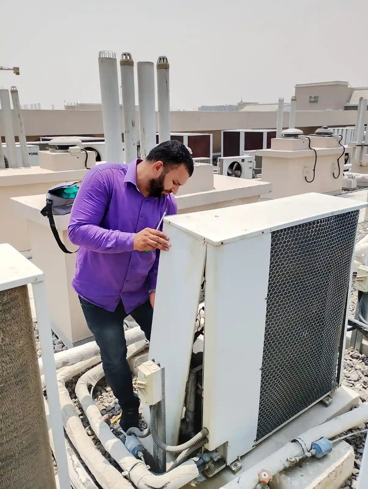 Technician servicing a wall-mounted split AC inside a Dubai home — supporting project view 2