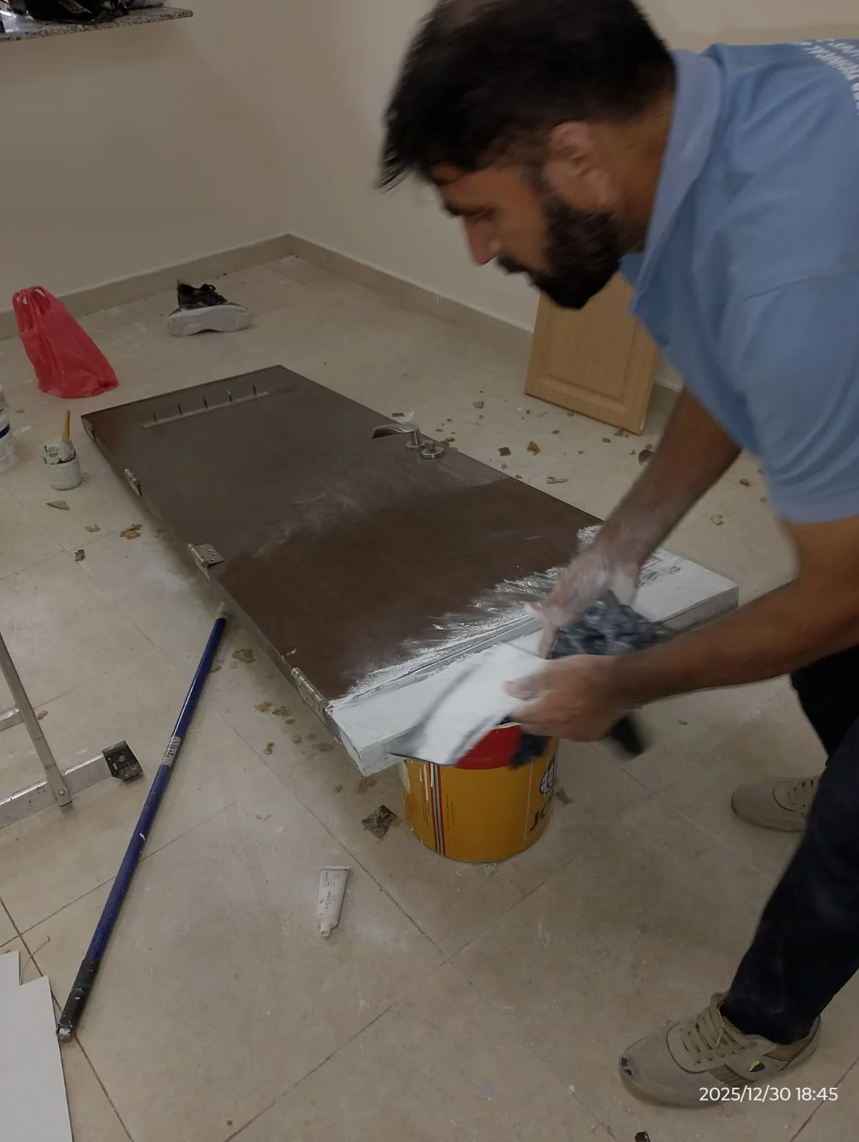 Technician repairing a kitchen cabinet panel in Dubai — supporting project view 1