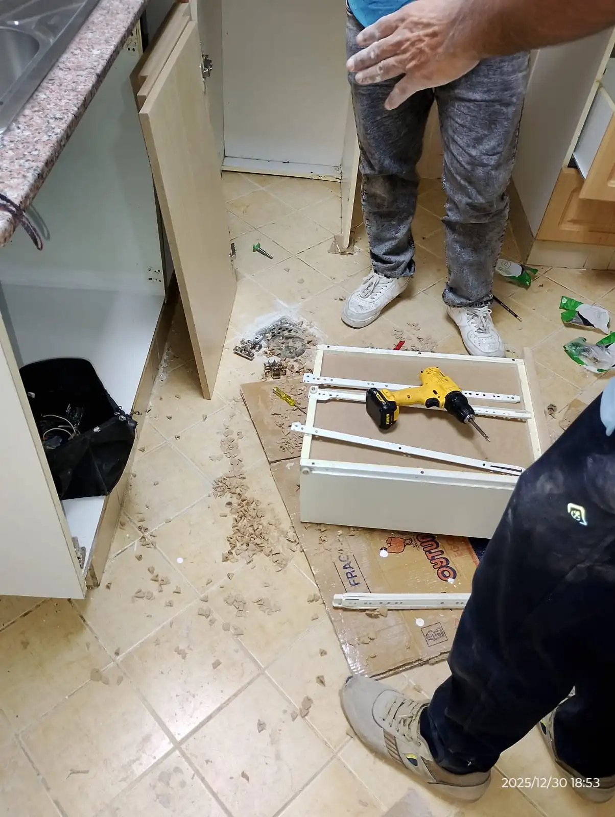 Technician repairing a kitchen cabinet panel in Dubai — supporting project view 2