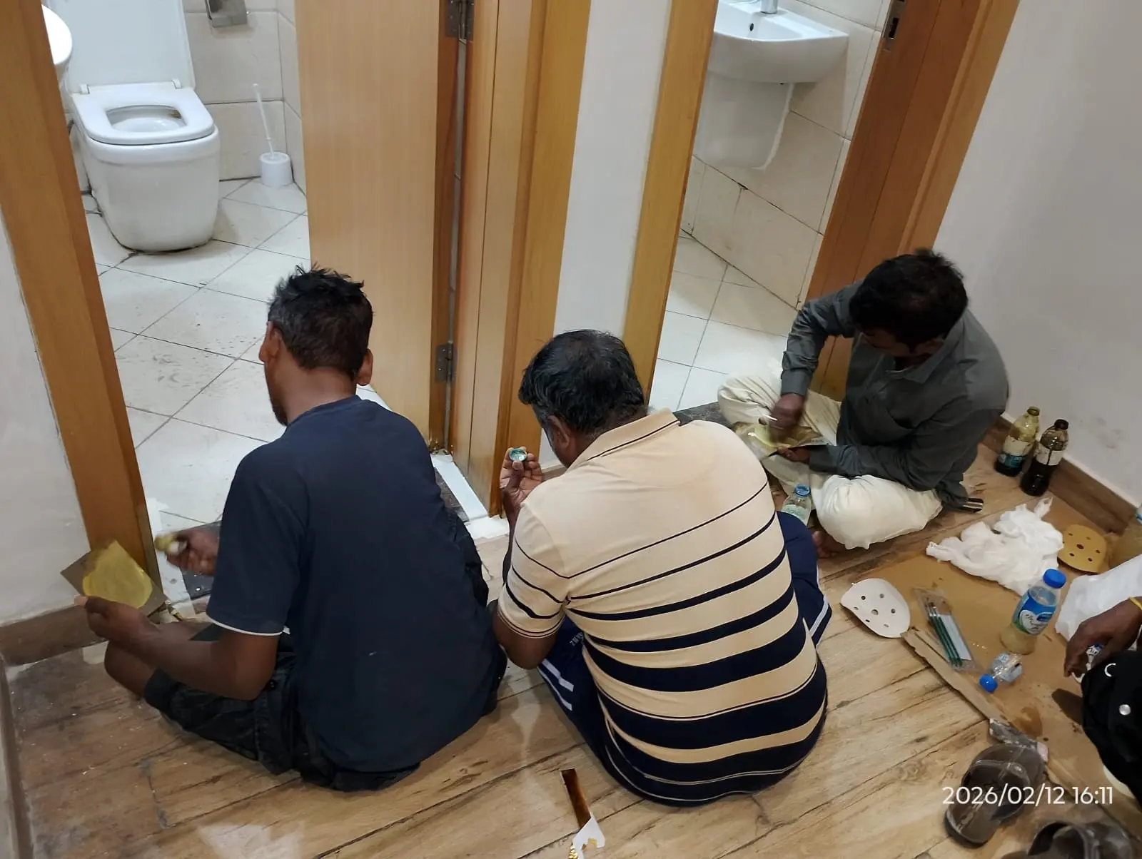 Technician repairing the lower section of a wooden door in Dubai — supporting project view 1