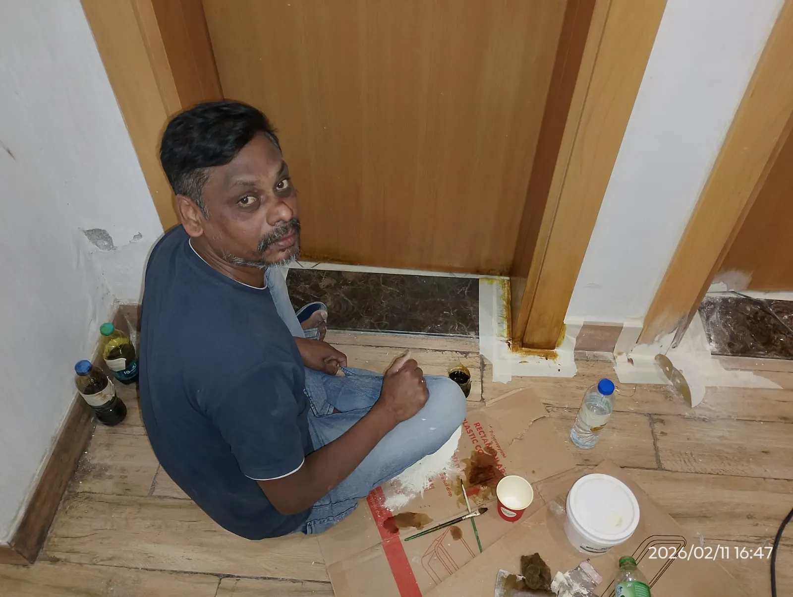 Technician repairing the lower section of a wooden door in Dubai