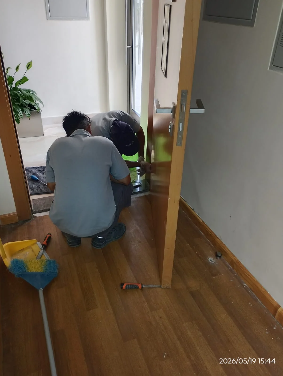 Technician repairing the lower section of a wooden door in Dubai — supporting project view 2