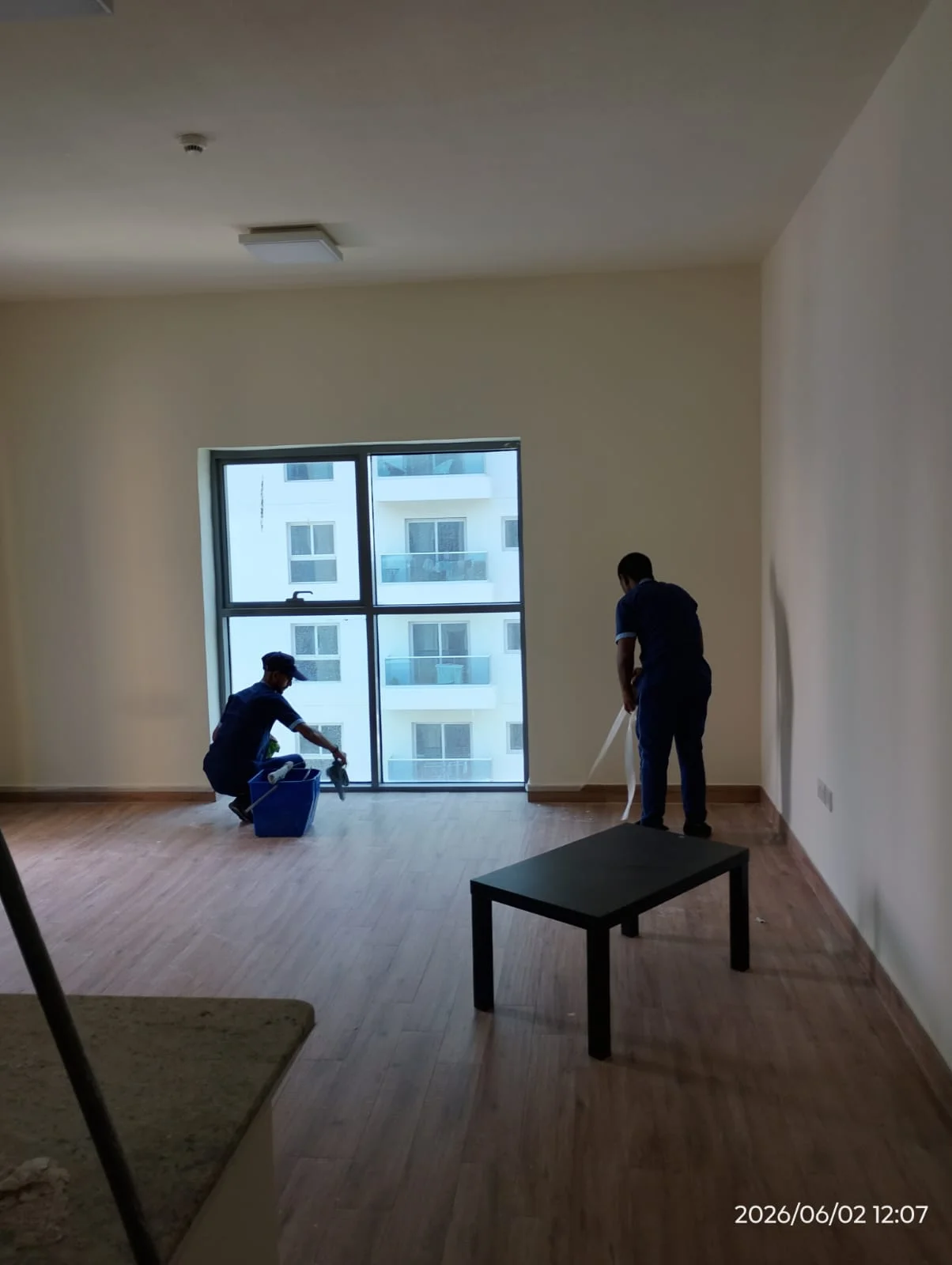 Cleaner washing a large apartment window in Dubai — supporting project view 1