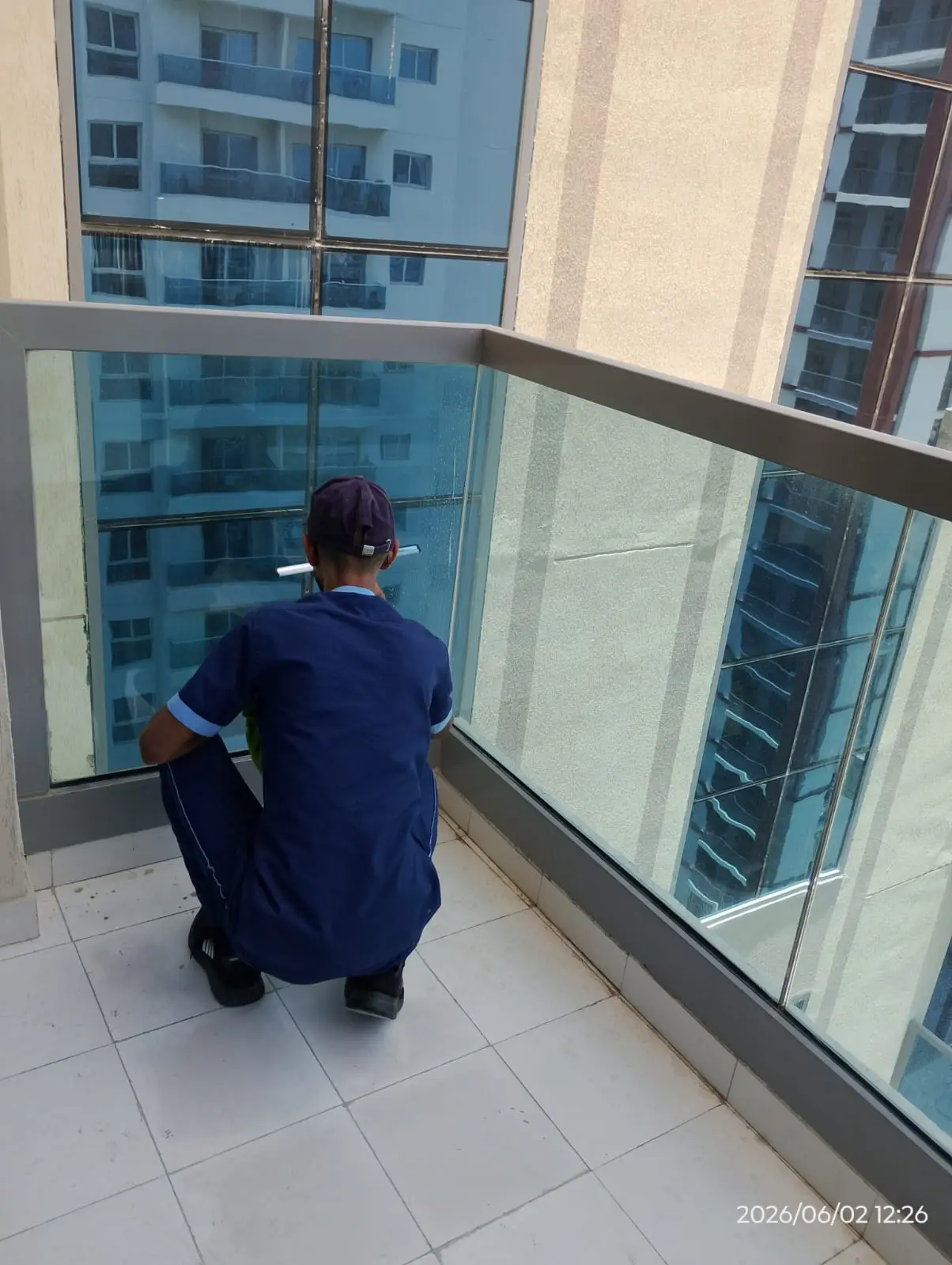 Cleaner washing a large apartment window in Dubai — supporting project view 2
