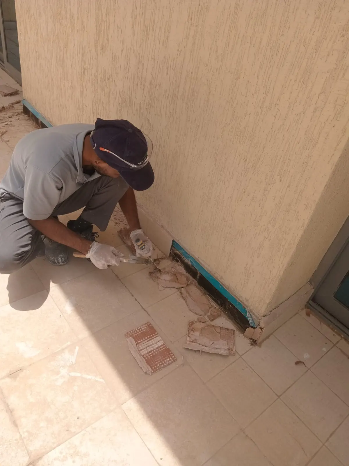 Technician repairing floor tiles in a Dubai property — supporting project view 3