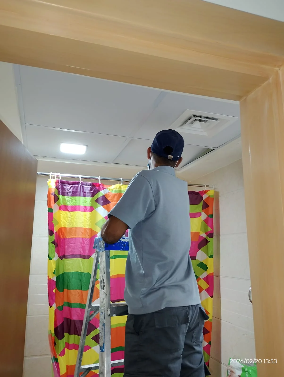 Technician installing curtains beside a large window in a Dubai apartment — supporting project view 1