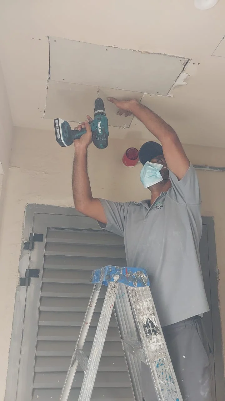 Technician carrying out a minor ceiling repair inside a Dubai property — supporting project view 2