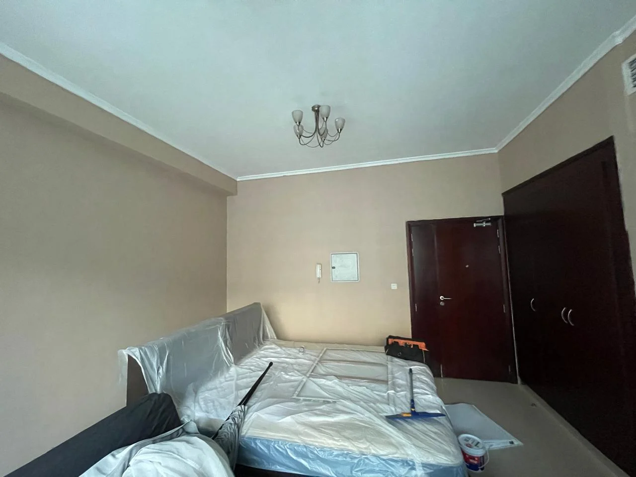 Painter applying wall paint in a Dubai apartment bedroom — supporting project view 1