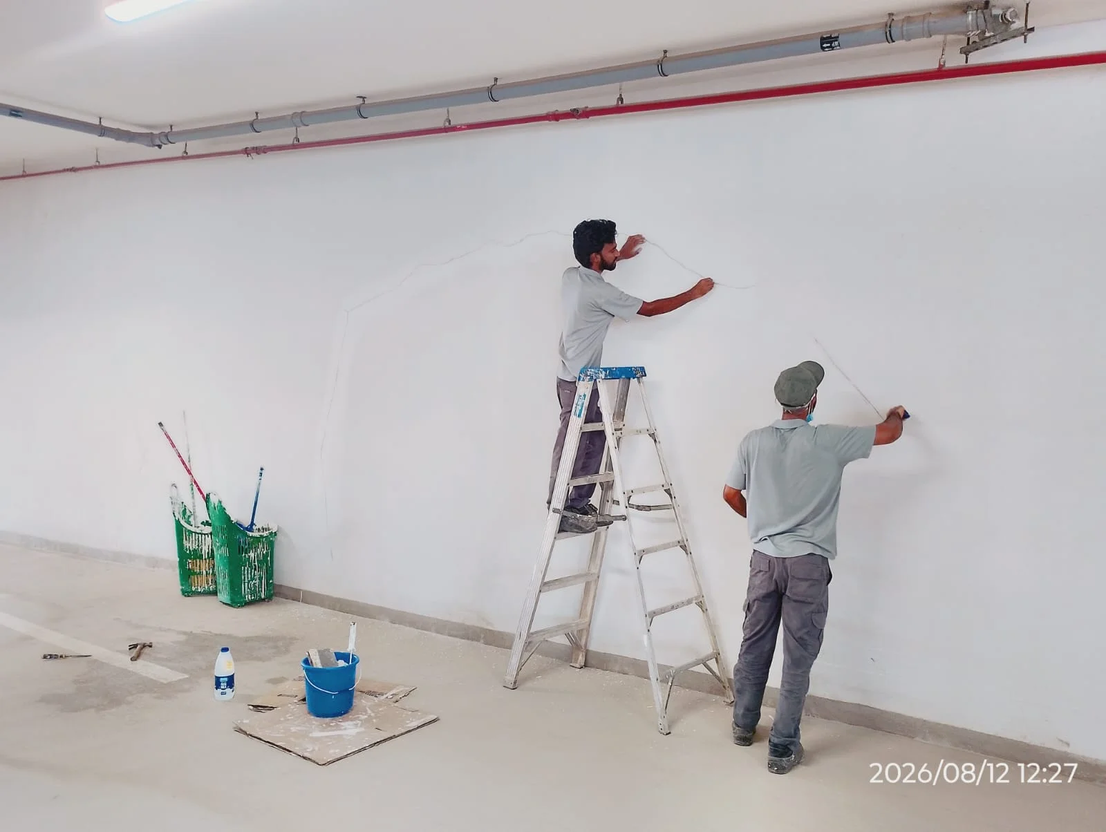 Painters applying wall paint inside a Dubai property
