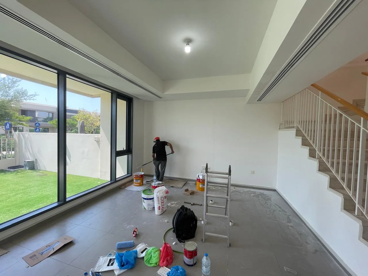 Painter working inside a villa living area in Dubai — supporting project view 1