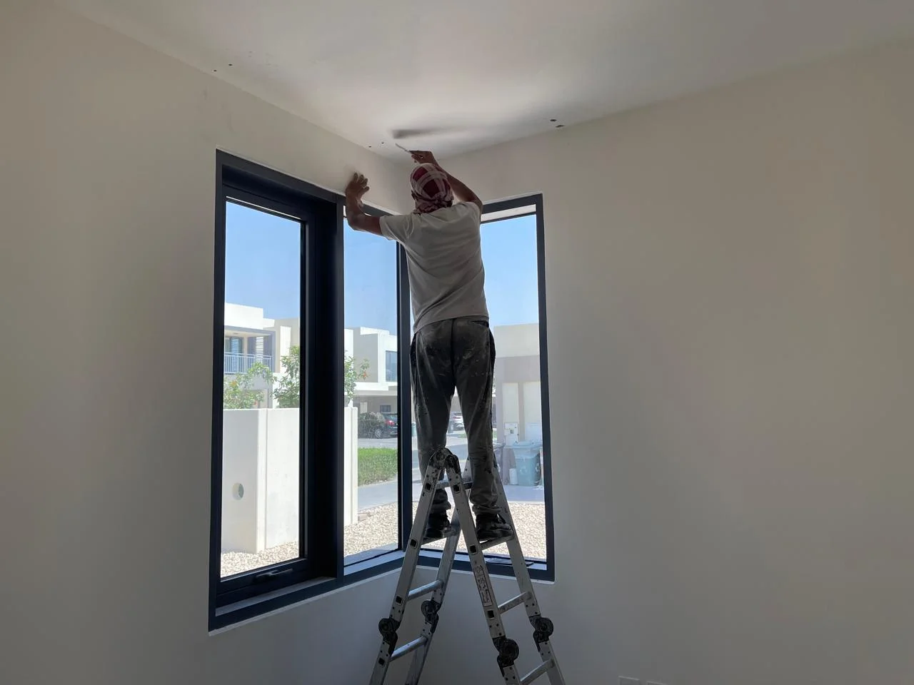 Painter working inside a villa living area in Dubai — supporting project view 3