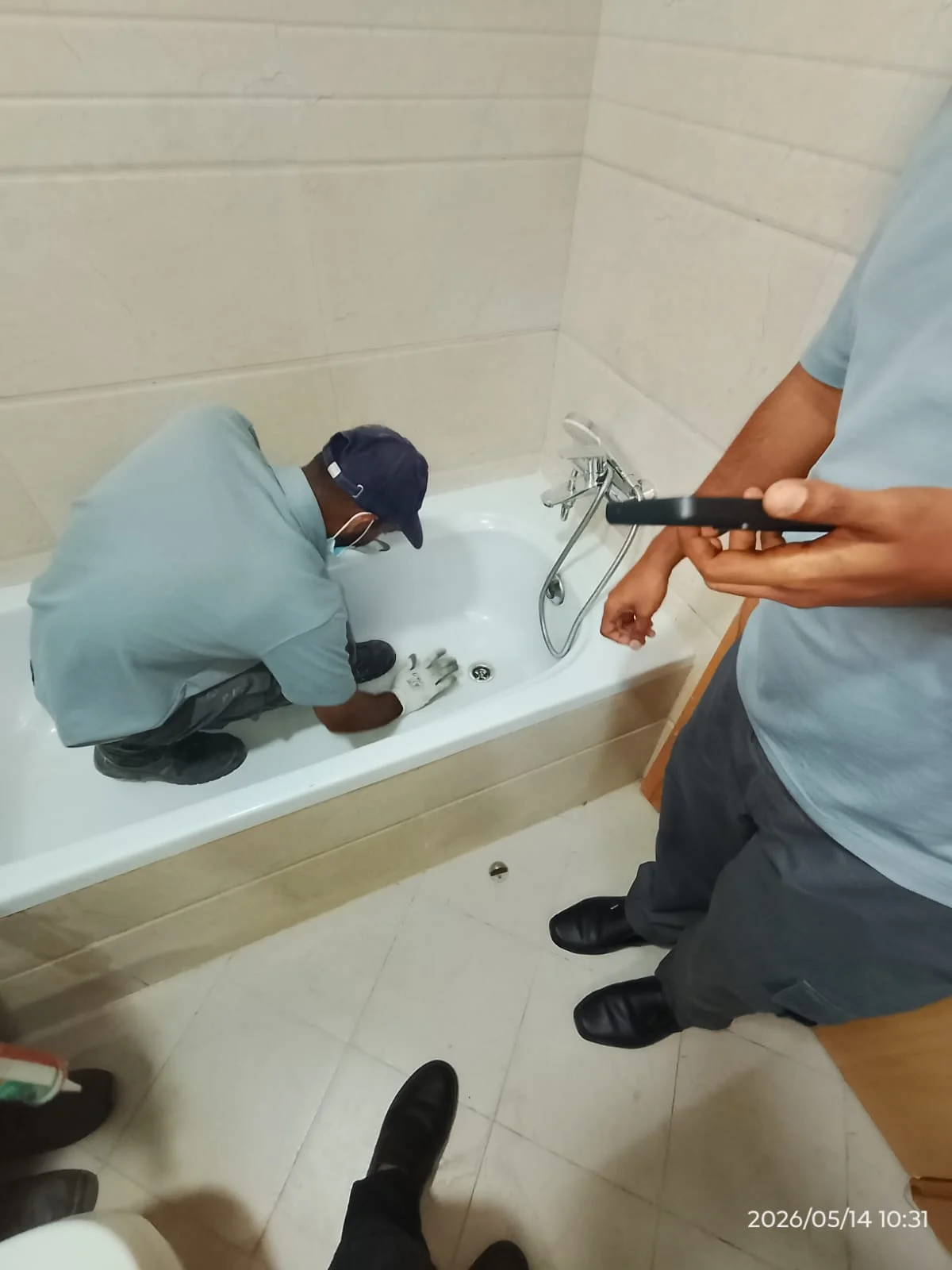 Technician carrying out bathroom plumbing work beside a toilet in Dubai — supporting project view 1