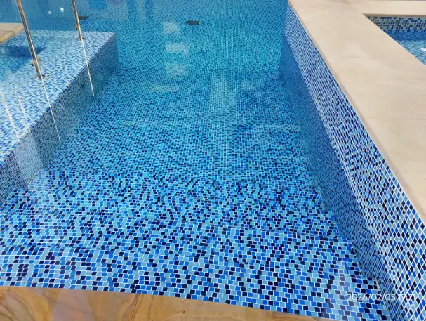 Technician cleaning an outdoor swimming pool in Dubai — supporting project view 1