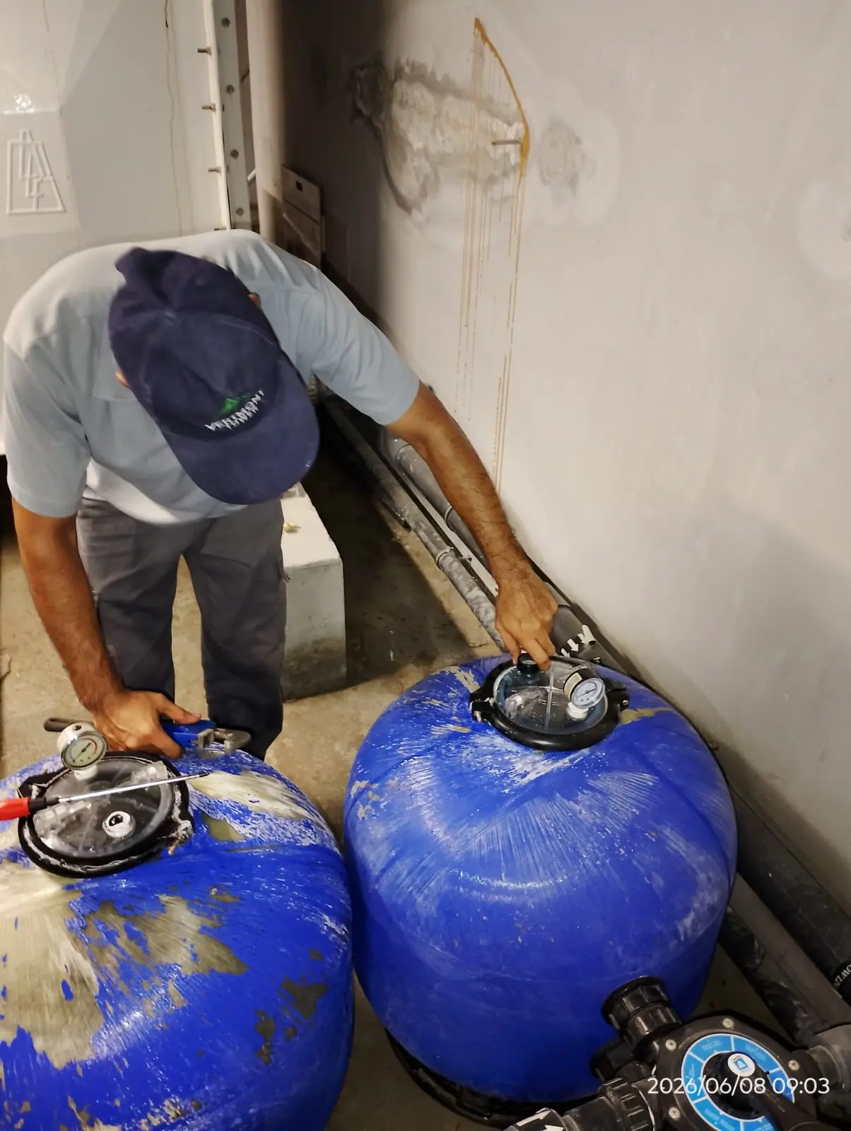 Technician checking pool pump and filtration equipment in Dubai — supporting project view 1