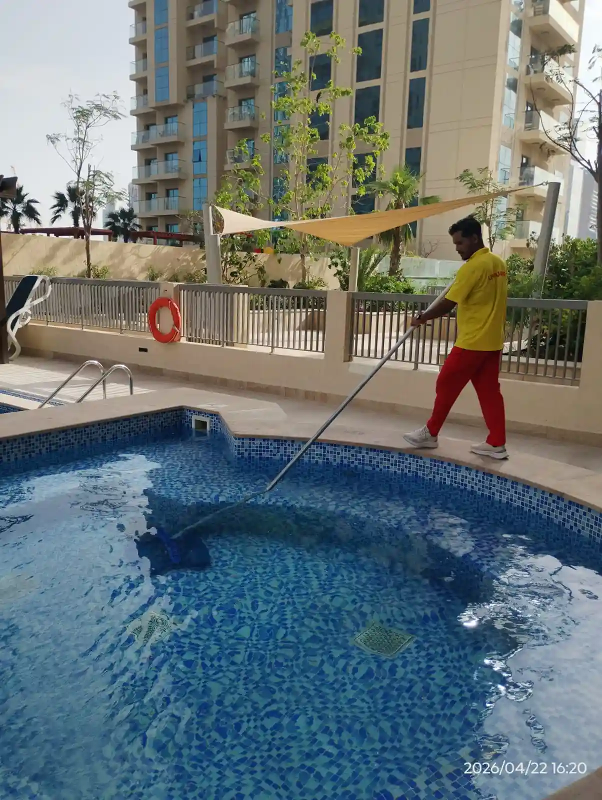 Technician carrying out pool maintenance at a Dubai property