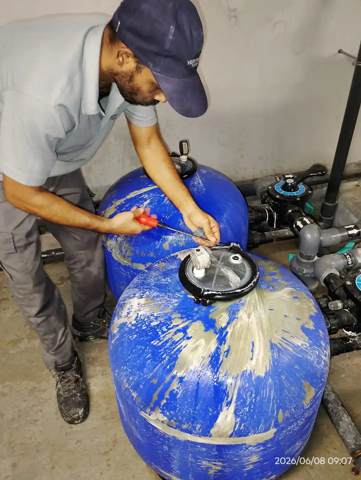 Technician maintaining an outdoor swimming pool in Dubai — supporting project view 3