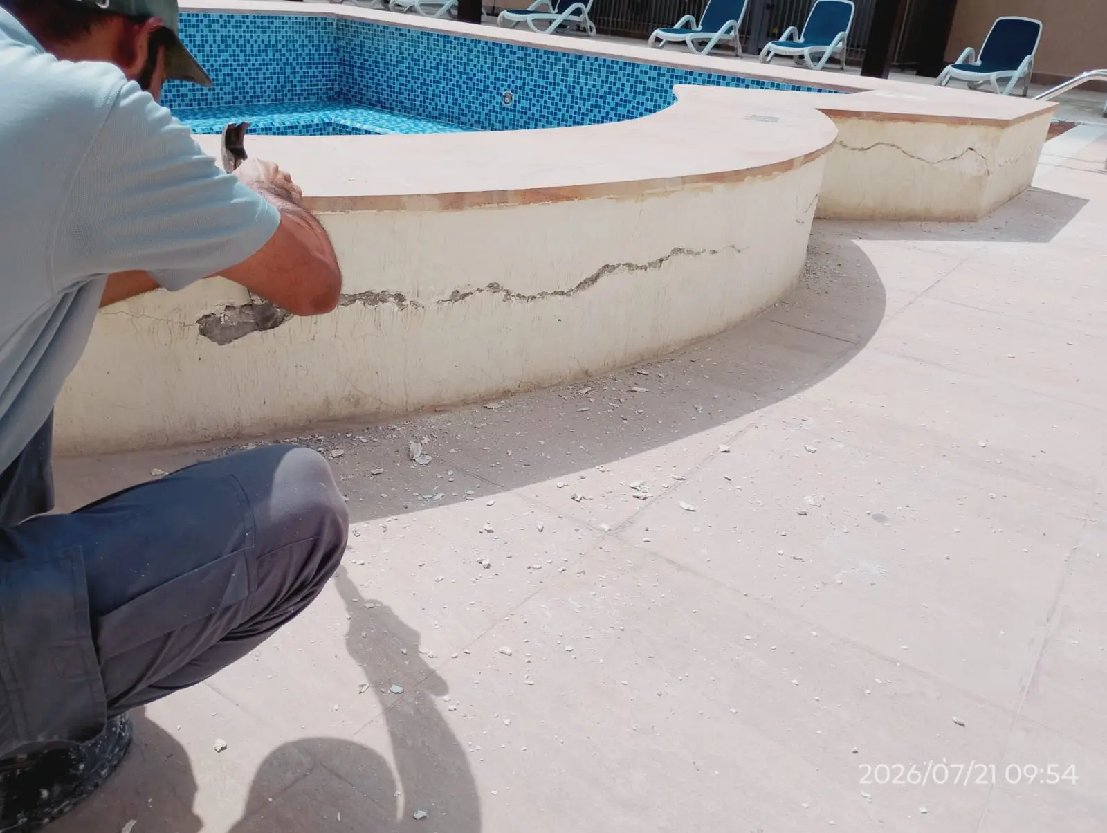 Technician repairing the tiled edge of a swimming pool in Dubai — supporting project view 2