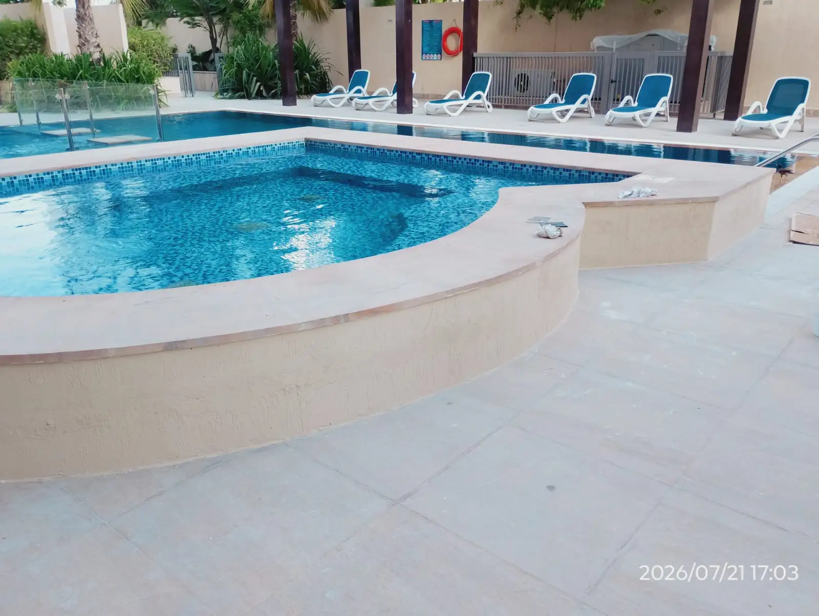Technician repairing the tiled edge of a swimming pool in Dubai — supporting project view 3