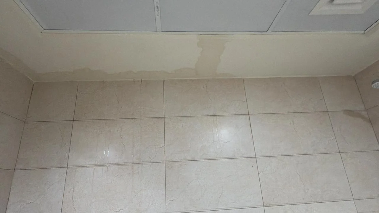 Technician applying waterproofing treatment to a bathroom floor in Dubai — supporting project view 1