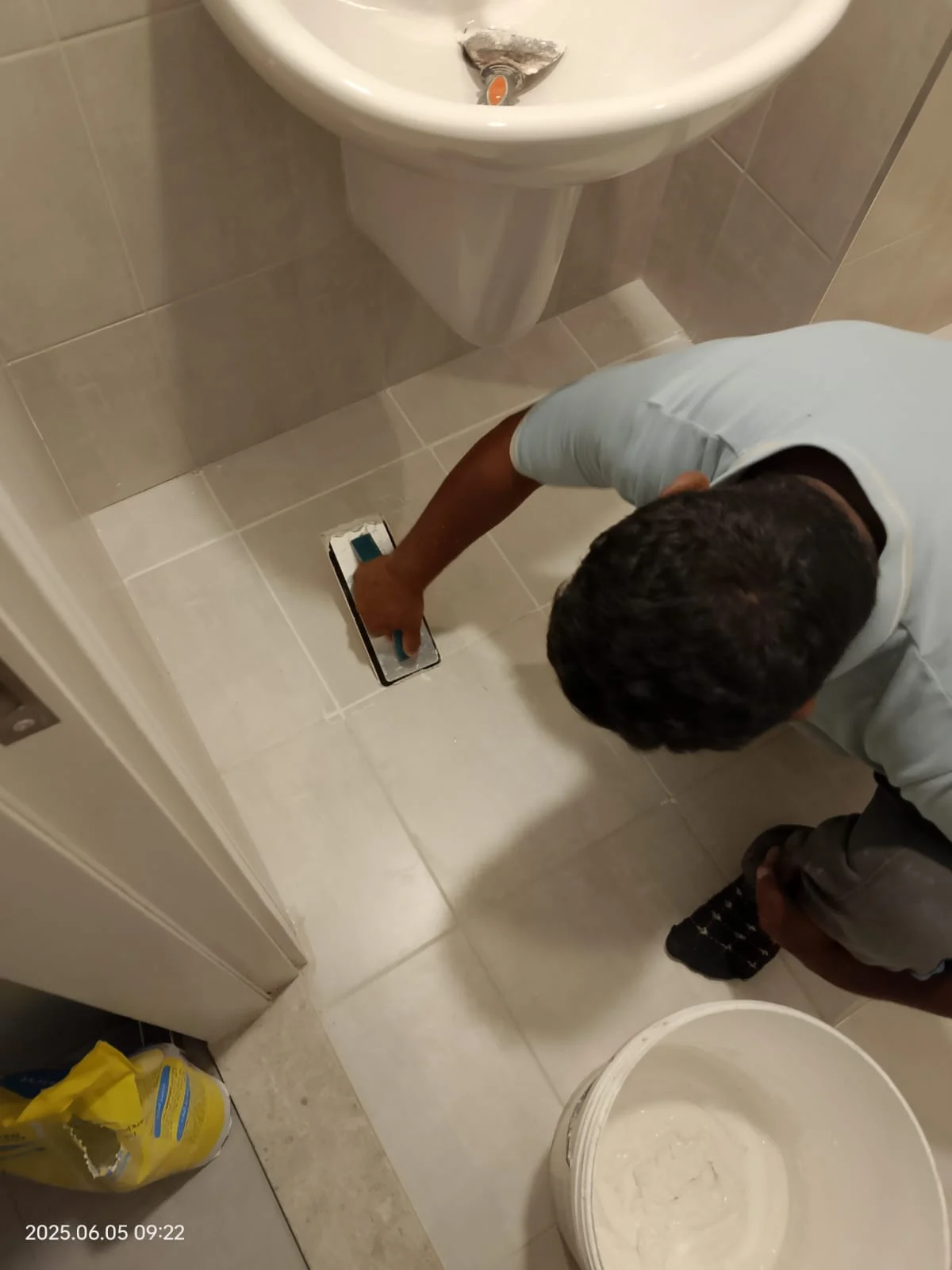 Technician applying waterproofing treatment to a bathroom floor in Dubai — supporting project view 2