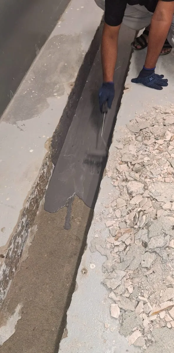 Technician applying waterproofing material along an exposed surface in Dubai — supporting project view 1