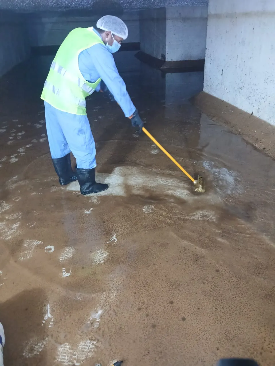 Cleaning team working inside a large water tank in Dubai — supporting project view 1