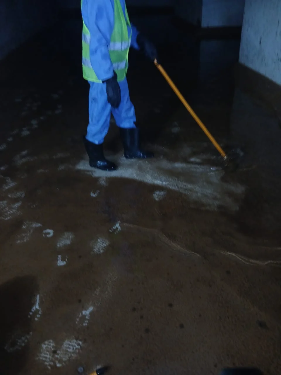 Technician disinfecting the inside wall of a water tank in Dubai — supporting project view 2
